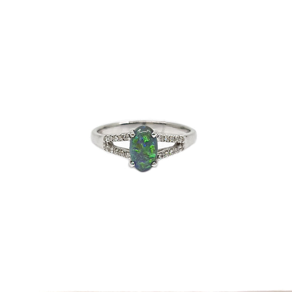 A luxurious 18ct white gold ring featuring a luminous, oval-cut Lightning Ridge black opal claw-set in the center, flanked by sparkling diamonds on its band, showcasing a spectrum of vibrant colors. | Fremantle Opals