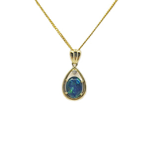 Elegant 9ct yellow gold pendant featuring a luminous claw-set triplet opal with iridescent blues and greens, highlighted by a sparkling diamond at the top. | Fremantle Opals