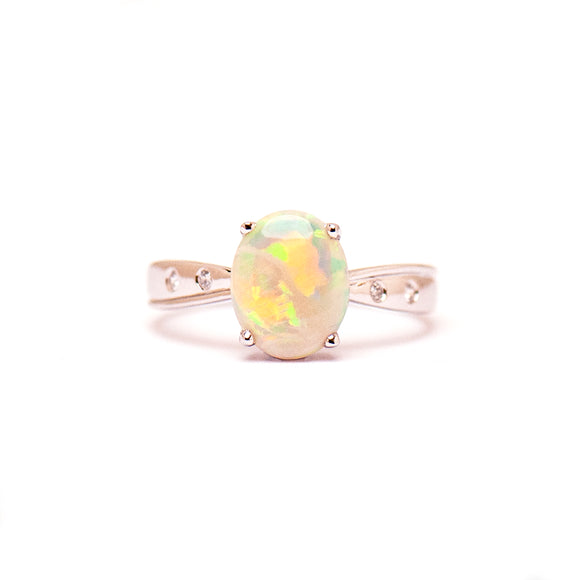 Sterling silver ring showcasing a luminous light opal with vibrant color play, complemented by delicate cubic zirconia accent stones. | Fremantle Opals