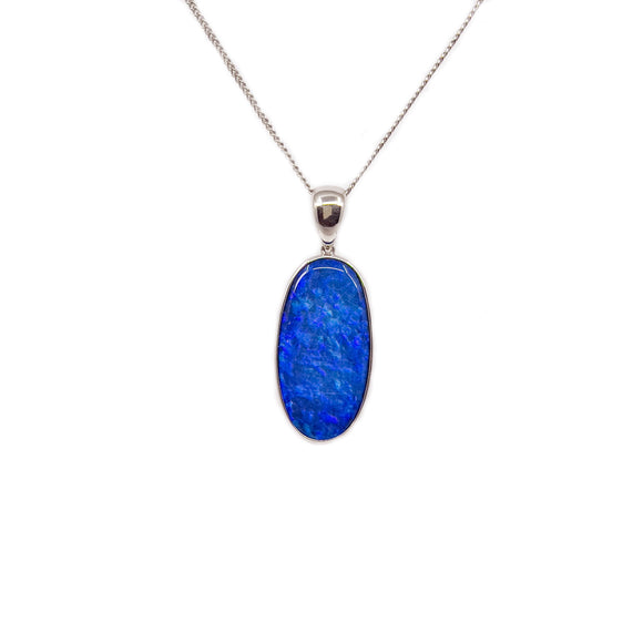 A sterling silver pendant with a vivid blue Australian doublet opal, bezel-set and crowned with a glinting cubic zirconia. The pendant suspends from a matching silver plated chain. | Fremantle Opals