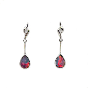 A pair of 14ct white gold earrings featuring teardrop-shaped Australian doublet opal drops. Each opal displays vibrant red and multicolored flashes set in a flowing, elongated design, creating an elegant and sophisticated appearance. | Fremantle Opals