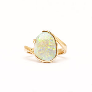 14ct yellow gold ring featuring a luminous 3.25ct free-form cut light opal, set in a half bezel and claw setting with a wrap design band. | Fremantle Opals