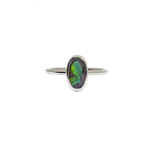 Sleek sterling silver ring featuring an oval boulder opal with a unique pattern of vivid green flashes set in a minimalist design | Fremantle Opals