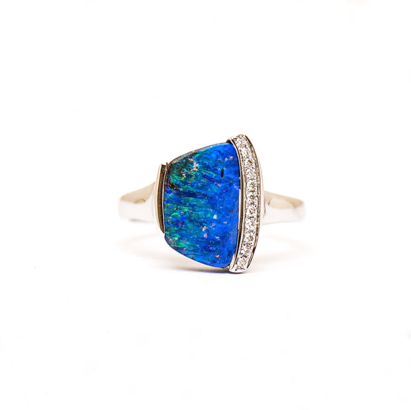 9ct white gold ring featuring a vibrant Queensland Boulder opal with shimmering blue and green hues, surrounded by sparkling diamonds. | Fremantle Opals