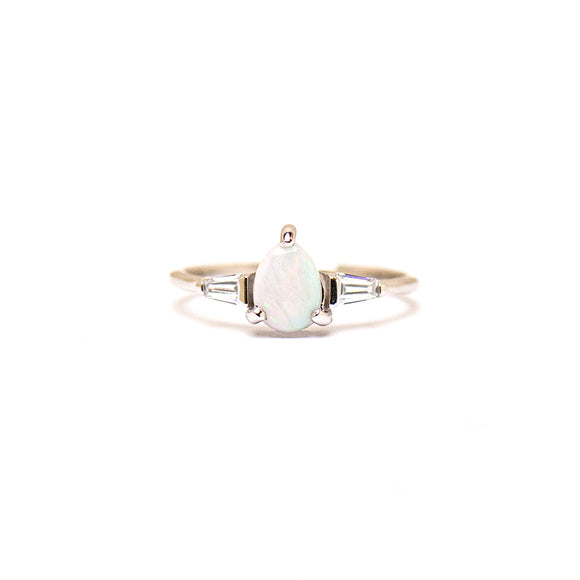 Sterling silver ring featuring a pear-cut white opal centerpiece, complemented by sparkling cubic zirconia accents on a polished band. | Fremantle Opals