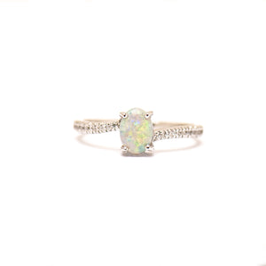 Sterling silver ring featuring a luminous solid light opal center, complemented by a band adorned with sparkling cubic zirconia stones. | Fremantle Opals