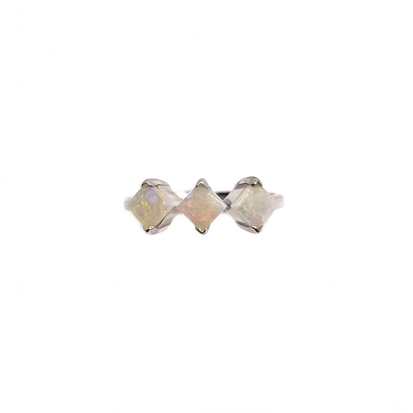 Sterling silver ring with a row of three square-cut Australian white opals showing a soft play of iridescent colors, set in a clean geometric design. | Fremantle Opals