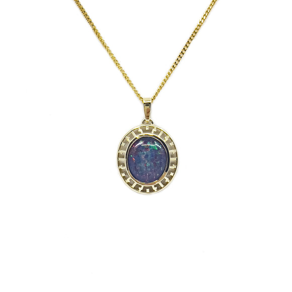A luxurious 9ct yellow gold pendant with a round, bezel-set triplet opal showcasing a vibrant array of colors, framed by an intricate Greek key design on the border. | Fremantle Opals