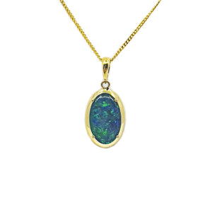 Elegant 9ct yellow gold pendant featuring a vibrant green and blue triplet Australian opal, oval-shaped and claw-set. | Fremantle Opals