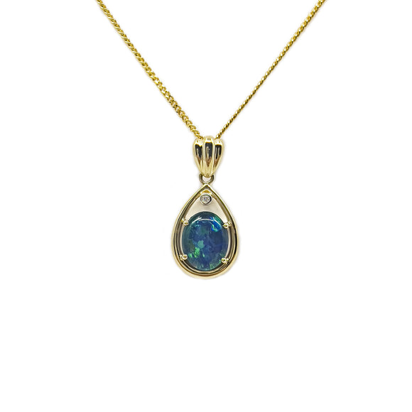 Elegant 9ct yellow gold pendant featuring a luminous claw-set triplet opal with iridescent blues and greens, highlighted by a sparkling diamond at the top. | Fremantle Opals