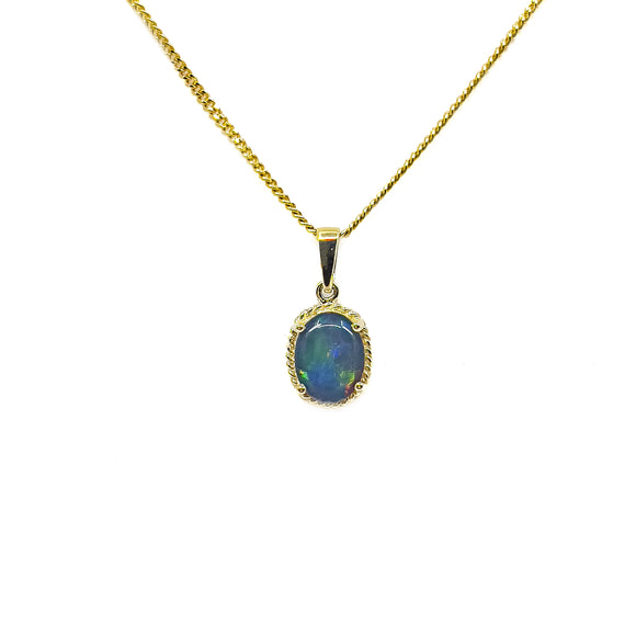 An exquisite 9ct yellow gold pendant featuring an oval Australian triplet opal with a dynamic display of blue and green colors, elegantly claw-set . | Fremantle Opals