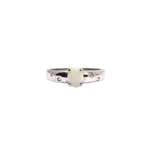 Sterling silver ring featuring a central Australian white opal encircled by sparkling cubic zirconia, showcasing unique color variations on a polished band. | Fremantle Opals